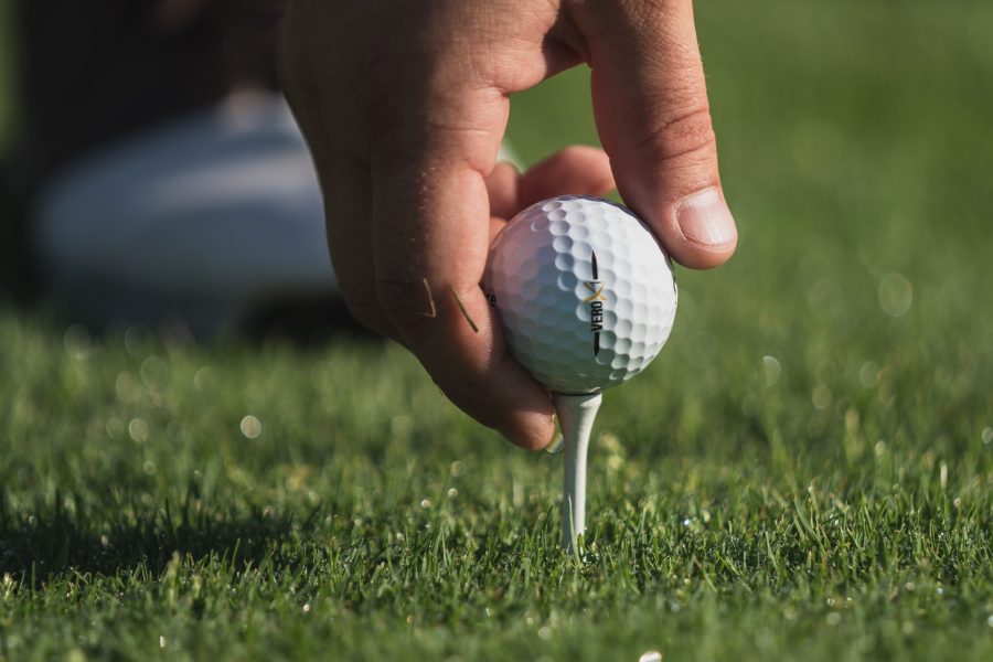 person holding white golf ball